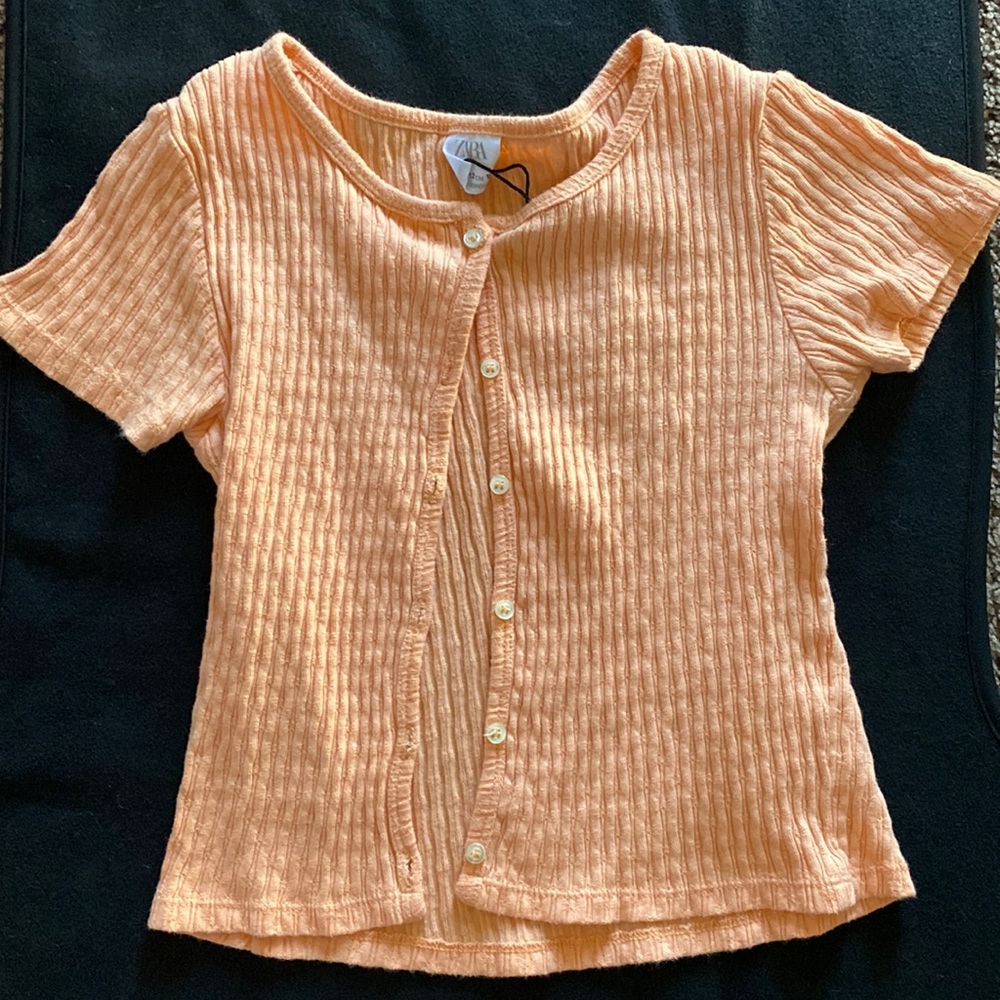 I am selling a orange button up shirt from Zara size 11-12